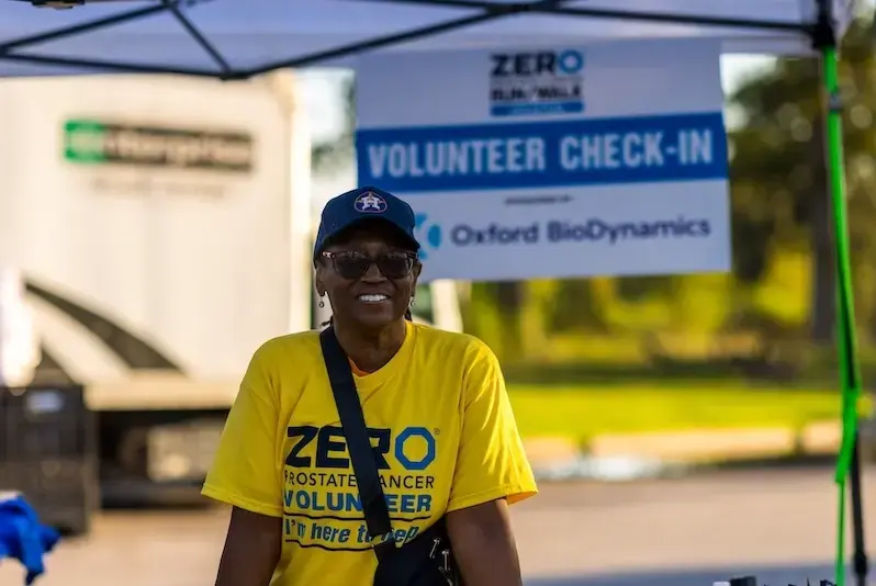 A representative from Oxford BioDynamics and a representative from ZERO Prostate Cancer smile at the camera.