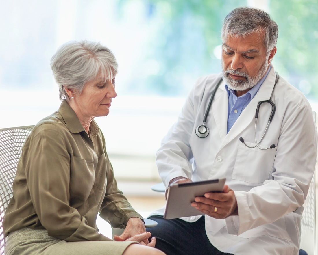 A doctor consulting with a patient about breast cancer A doctor consulting with a patient about breast cancer