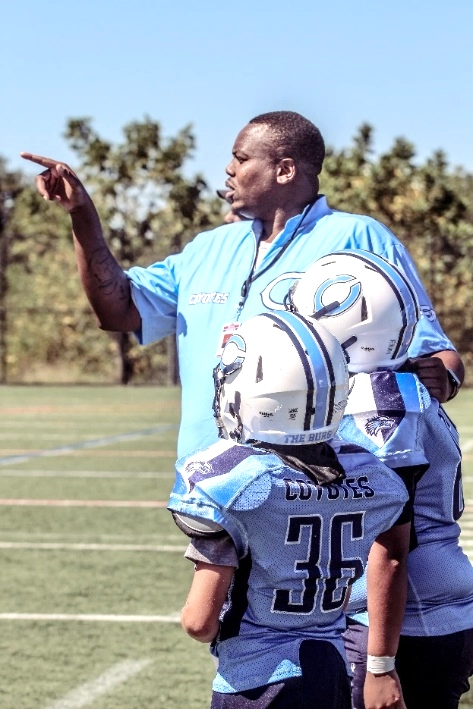 Clarksburg coach with youth football players