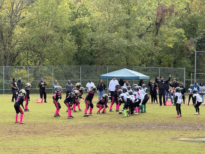 The Chiefs (in black and pink) on defense.